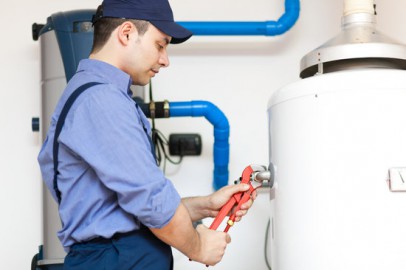 Plumber repairing an hot-water heater Plumber repairing an hot-water heater